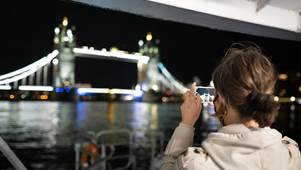 Lady taking photo of Tower Bridge