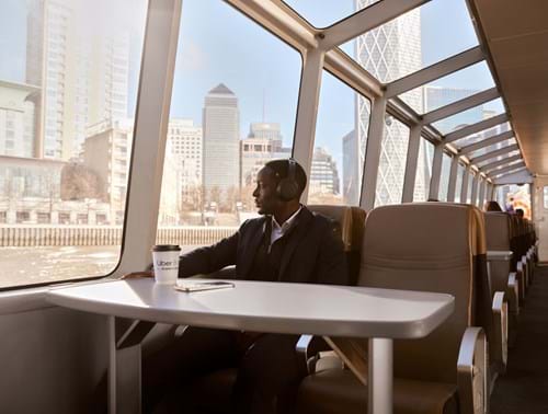 Commuter having coffee on board the River Bus